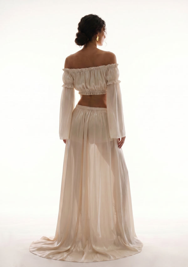Sirocco cream satin-chiffon maxi skirt back view worn on-model showing the floor-sweeping train and bell sleeves