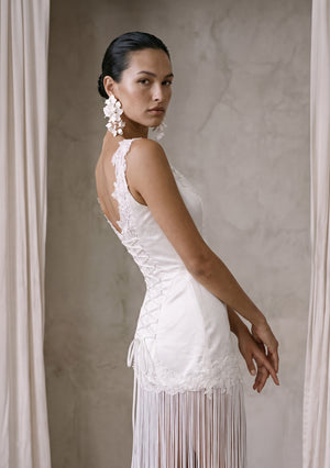 Lily Dress side view of the open upper back, lace-up and lace hem band with fringe