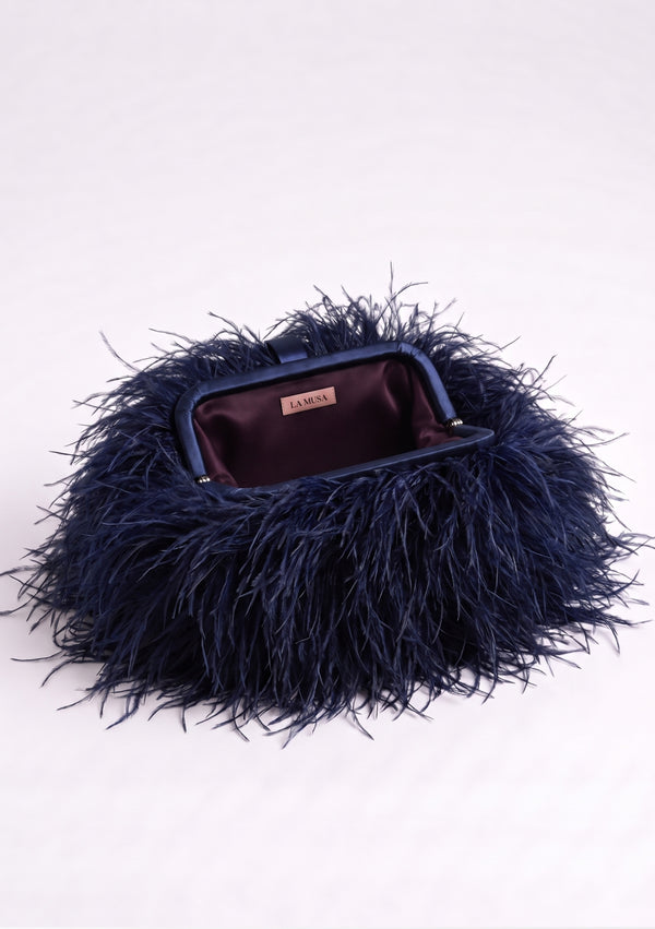 Ocean Feather Bag open: navy fabric-covered frame and plum lining with the La Musa label.