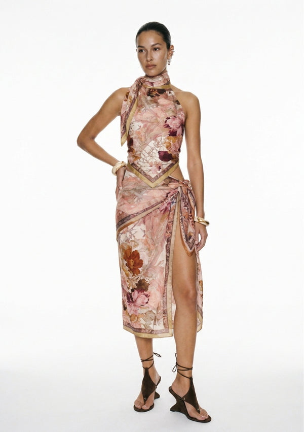 Full length view of the Nimue silk halter top styled with a matching printed wrap skirt and flat sandals