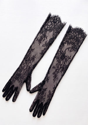 Eclipse black floral lace opera gloves, product-only flat lay showing sheer lace, fingered design and scalloped ruffle trim at the top opening