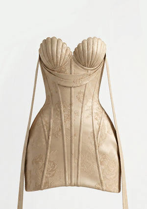 Nacre dress back view on model with corset lace-up and champagne floral jacquard, shot against a plain background
