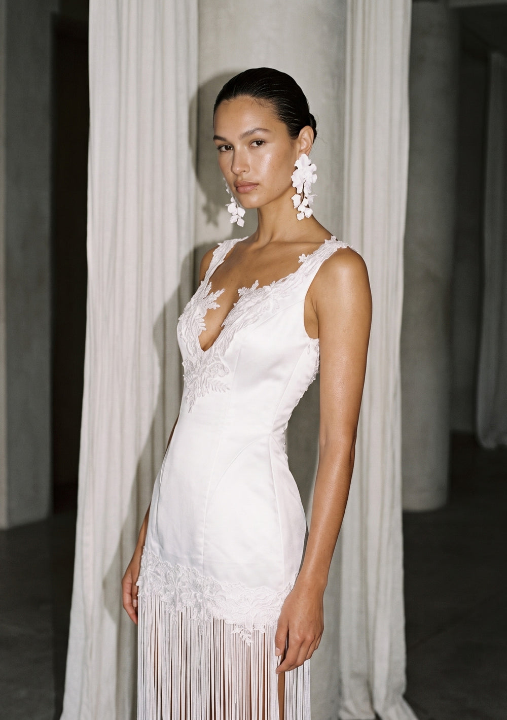 Lily fringe bridal dress, full-length front view: white satin V-neck mini with long fringe to the floor