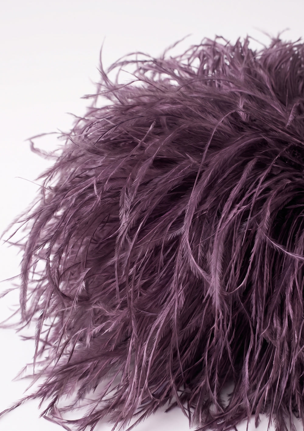 Plum Feather Bag, a dusty plum ostrich feather clutch, side view.