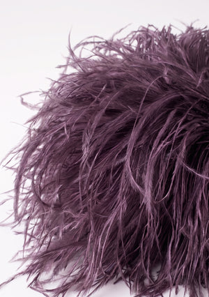 Close-up of the dusty plum ostrich feathers on the Plum Feather Bag.