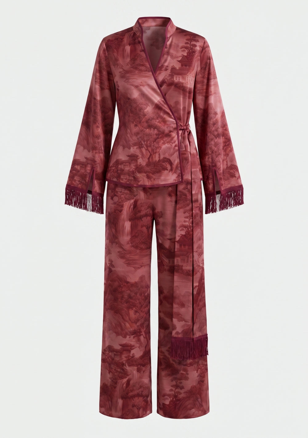 Crimson Dusk Set, burgundy printed satin pajama set, front view on model with the wrap top belted at the waist, fringed sleeve cuffs and wide-leg trousers worn with black flat sandals