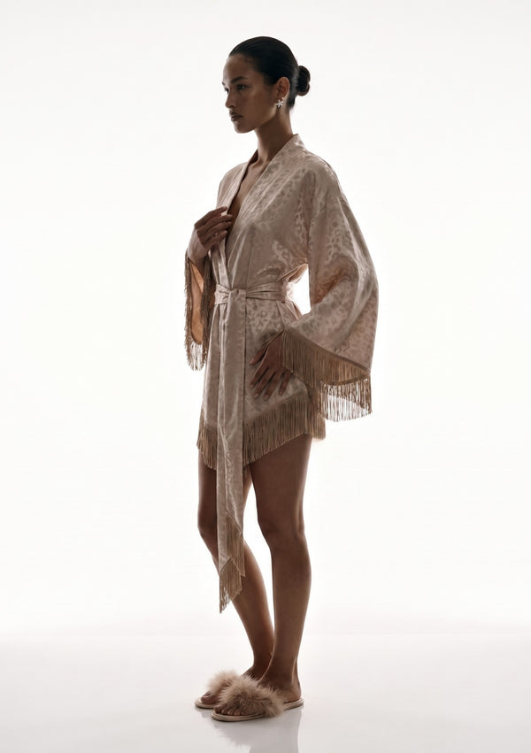 Full-length side view of the Feline robe worn belted, showing how short the hem sits and the fringed sash falling past it