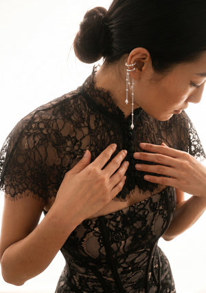 Eclipse Cape worn over a black lace corset, close-up front view of mandarin collar and center-front covered buttons