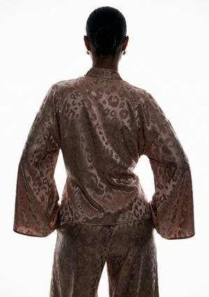 Back of the Feline wrap shirt, showing the dropped shoulder seam and the sleeves falling wide at the wrist