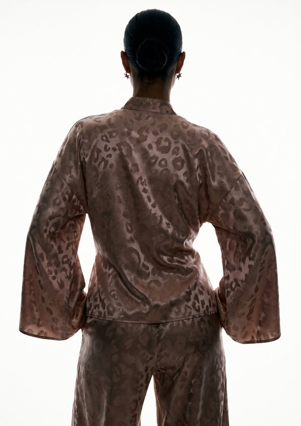 Back of the Feline wrap shirt, showing the dropped shoulder seam and the sleeves falling wide at the wrist