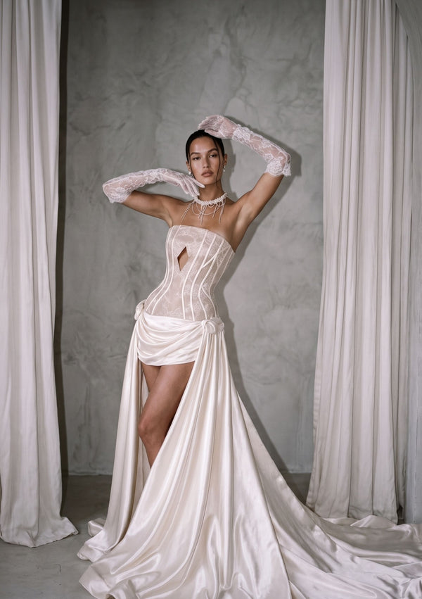 Anthurium lace corset wedding dress, front view with the milk satin train and high slit, styled with lace opera gloves and a pearl choker