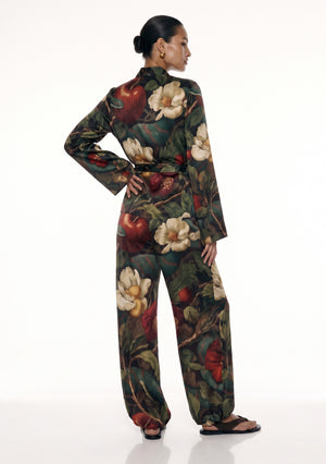 Back view of the Eden silk pajama set, showing the stand collar, the sash tied at the waist and the print running the length of the trousers