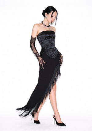 Spell Skirt with long black fringe along a high diagonal slit, styled with the Spell Corset and heels.