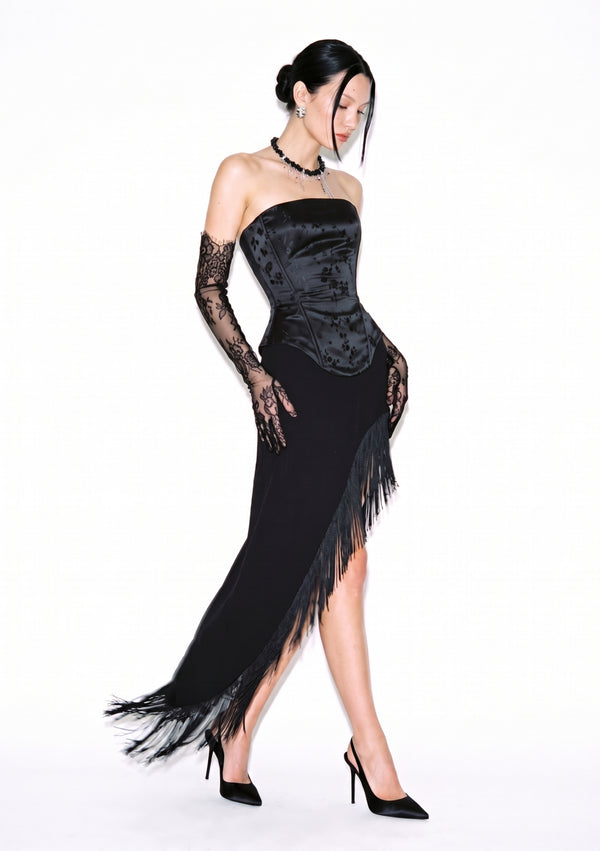 Spell Skirt with long black fringe along a high diagonal slit, styled with the Spell Corset and heels.
