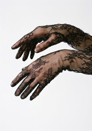Close-up of both hands in the Eclipse black floral lace opera gloves, showing the fingered sheer lace detail