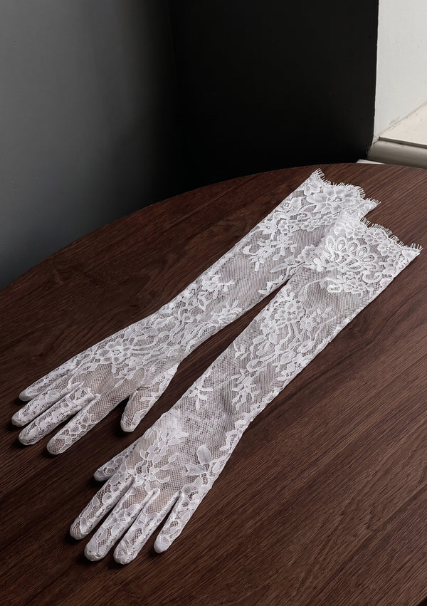 Etherea white lace opera gloves laid flat side by side, close view of the corded floral lace and scalloped fringe edge