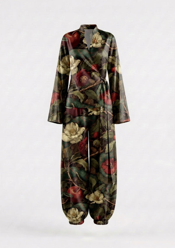 Eden silk set shown on an invisible mannequin, wrap top with its self-tie sash knotted at the side above wide trousers finishing in elasticated ankle cuffs