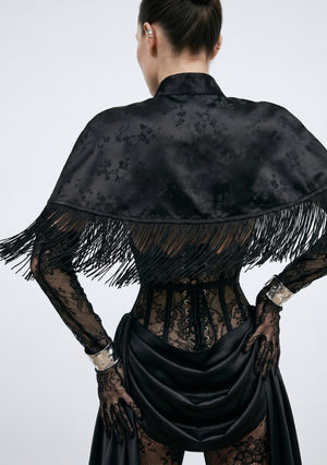 La Musa Baccara black jacquard fringe capelet, back view, layered over the Baccara corset and skirt