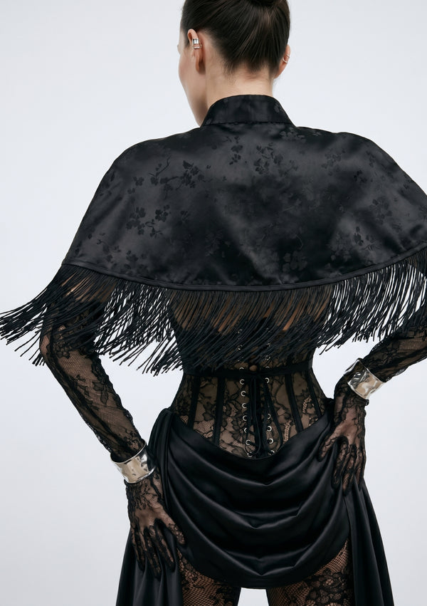La Musa Baccara black jacquard fringe capelet, back view, layered over the Baccara corset and skirt