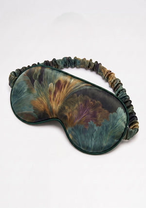 Sylvara padded eye mask with a ruffled elastic strap in forest green botanical print with bronze and muted violet