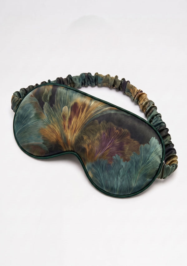 Sylvara padded eye mask with a ruffled elastic strap in forest green botanical print with bronze and muted violet