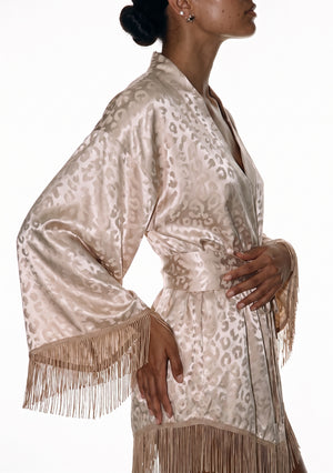 Close side view of the Feline robe, shawl collar and wide sash at the waist above the fringed sleeve