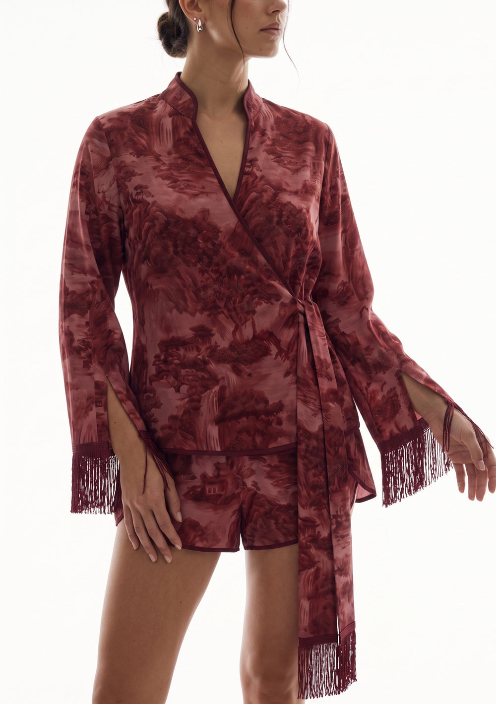 Crimson Dusk Mini Set, close-up of the wrap front, cuff slits and silk fringe over the high-waisted burgundy satin mini shorts