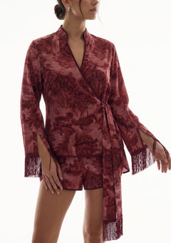 Crimson Dusk Mini Set, close-up of the wrap front, cuff slits and silk fringe over the high-waisted burgundy satin mini shorts