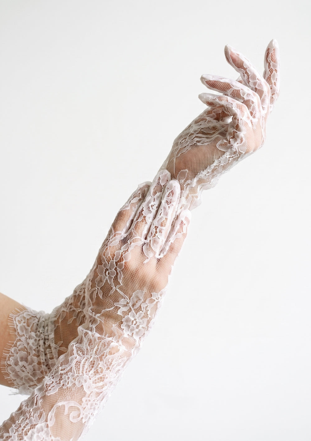 White floral lace opera gloves worn above the elbow with the Lucentia toile corset dress, one hand at the shoulder and one at the waist