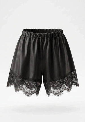 Black satin shorts product shot showing elastic gathered waistband and wide scalloped floral lace hem