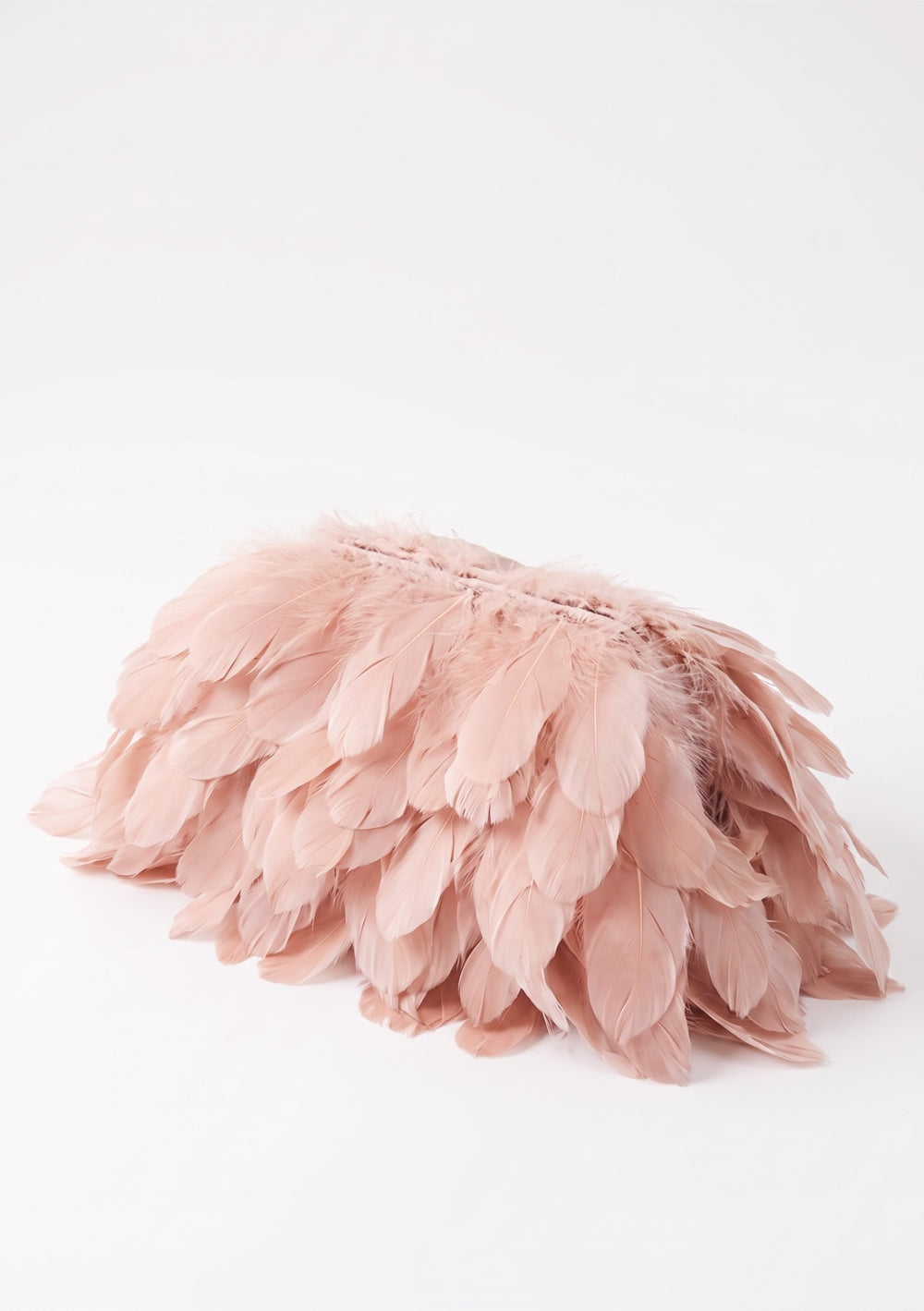 Petal Feather Bag, a blush pink feather clutch bag of larger structural feathers, side view.