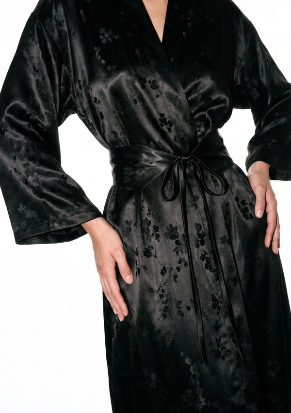 Close-up of the Tenebrae Robe front, V neckline, belted waist and the tonal floral woven into the black satin jacquard