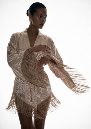Feline robe caught mid-movement, fringe swinging out from the sleeve and the asymmetric hem