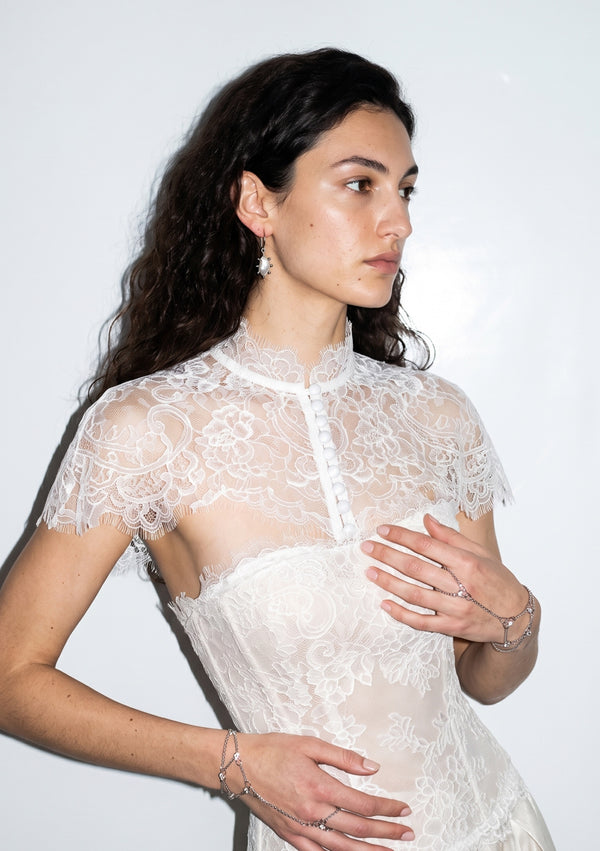 Etherea floral lace capelet with high collar and covered-button front, worn over a matching lace corset bodice