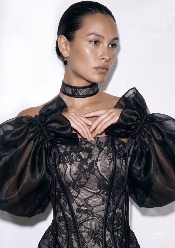 Close view of the Eclipse sleeves at the shoulder, ruffled organza edge gathered on a ribbon that ties into a bow