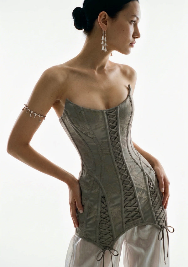 Side view of the grey jacquard Lucentia corset mini dress with sculptural boning and lace-up panels