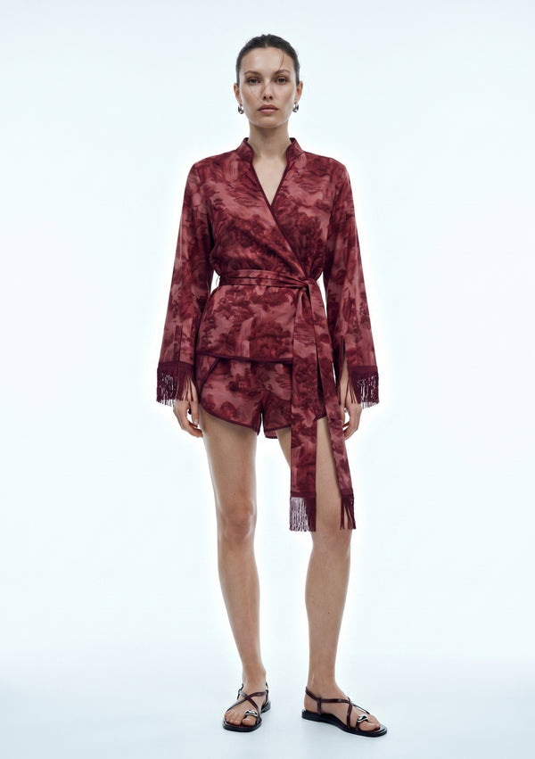 Crimson Dusk Mini Set, front view with the satin sash tied at the centre waist and fringe hanging over the burgundy mini shorts