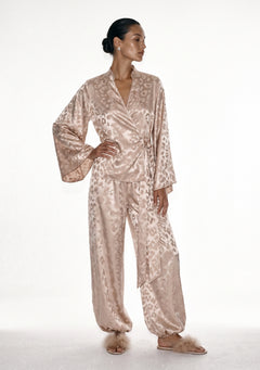 Feline beige leopard jacquard set on model, wrap shirt tied at the side over trousers gathered at the ankle