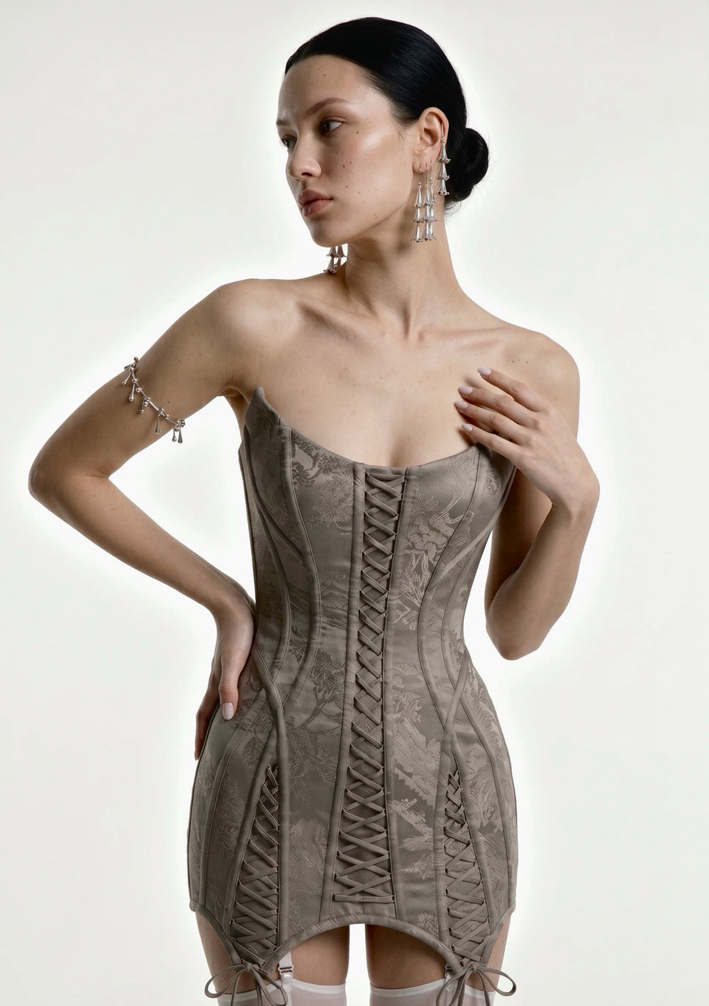 Grey jacquard Lucentia corset mini dress with front lace-up panels and pointed tie hem, front view on model