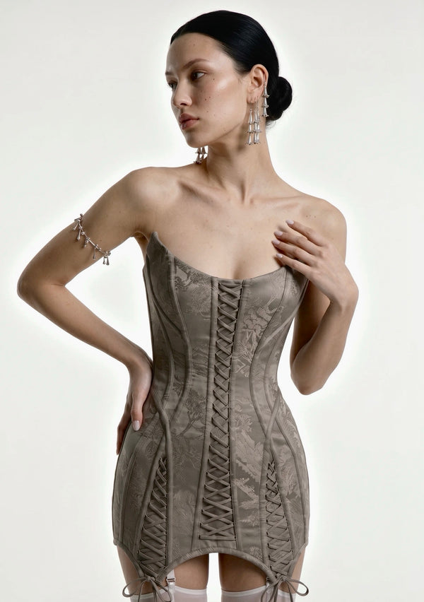 Grey jacquard Lucentia corset mini dress with front lace-up panels and pointed tie hem, front view on model