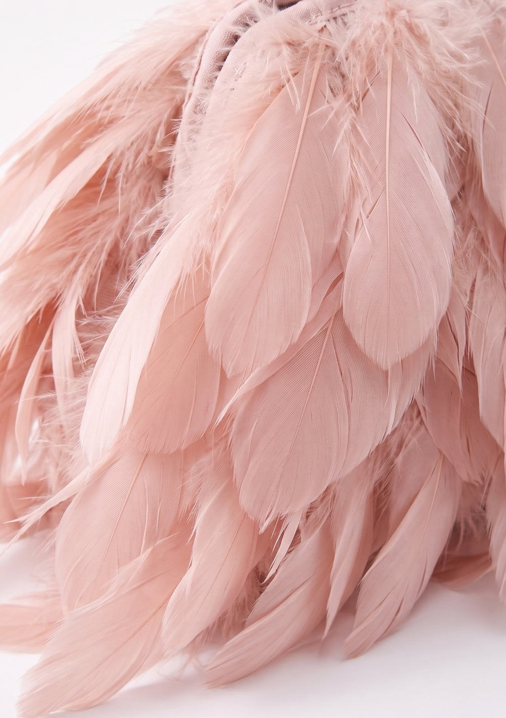 Petal Feather Bag, a blush pink feather clutch bag of larger structural feathers, side view.