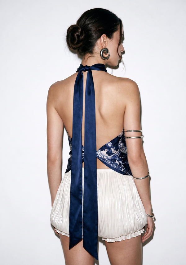 Back view of the Mirage Peony silk top, showing the bare open back and the two navy ties falling the length of the spine
