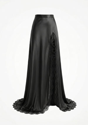 La Musa Midnight Skirt product shot: black satin maxi skirt with an asymmetric thigh-high slit edged in scalloped lace and corset ribbon-lacing, with a lace-trimmed hem