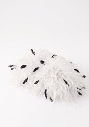 White Feather Bag closed, side view, white ostrich feathers with scattered black ones.
