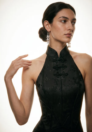 Close-up of the Vespera dress halter neckline, stand collar and decorative frog clasps