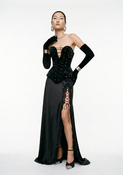 La Musa Midnight black satin maxi skirt with a high lace-edged thigh slit, styled with the Midnight corset, full-length front view