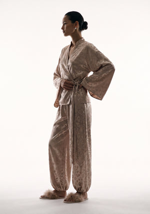 Full-length side view of the Feline set with the sash hanging long and the trousers cuffed above flat slides