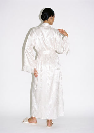 Full back view of the Moonveil robe, floor-length with the sash tied behind and fringe hanging from both sleeve cuffs