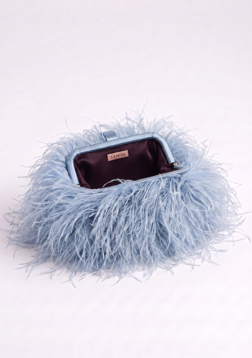 Blue Feather Bag open: pale blue ostrich feather clutch with a blue fabric-covered frame and plum lining.