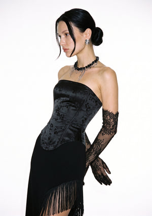 Spell Corset strapless corset top in black jacquard, hands behind the back, with the Spell Skirt and lace opera gloves.